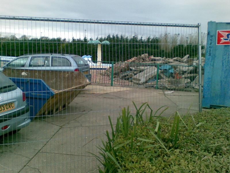 A pile of rubble beside the old outdoor pool