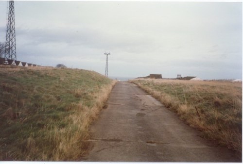 The road to the beach with Yellow Camp on the left and the sports field on the right. Some of the original 1940s chalets can just be seen in Yellow Camp