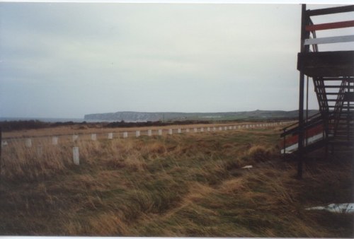 Looking out towards the coast from Blue Camp. The coast road can be seen behind the white bollards